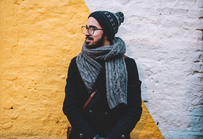 young trendy man walking in the street wearing eyeglasses purchased online