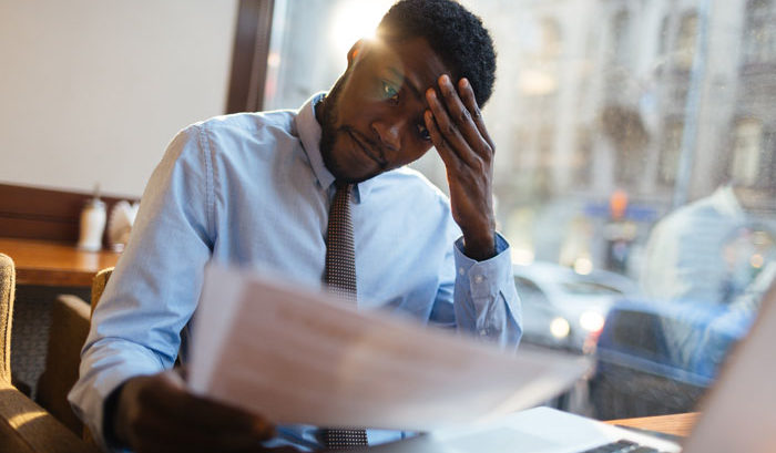 african american man stressed and dealing with depression at work